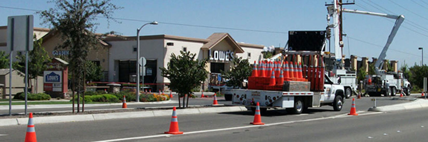 A KRC cone truck setting out a taper on a city street