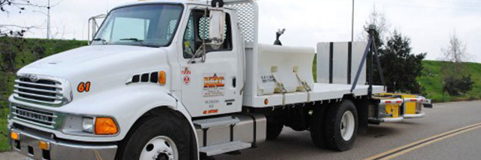 A KRC Safety flatbed truck, unit 61, loaded with barrier and equipment