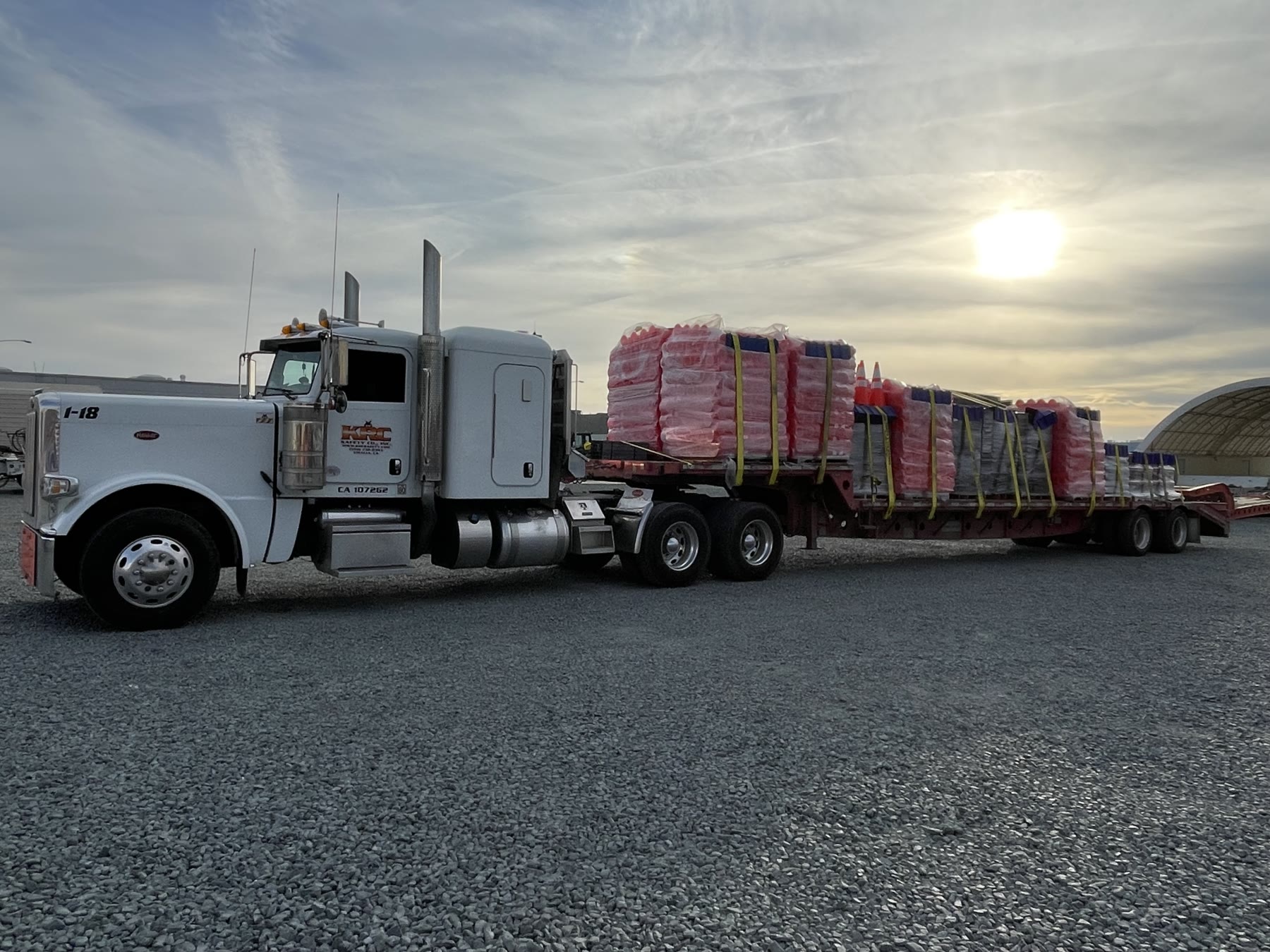 A KRC Safety Peterbilt tractor and flatbed loaded with crash cushions and cones at the Visalia yard